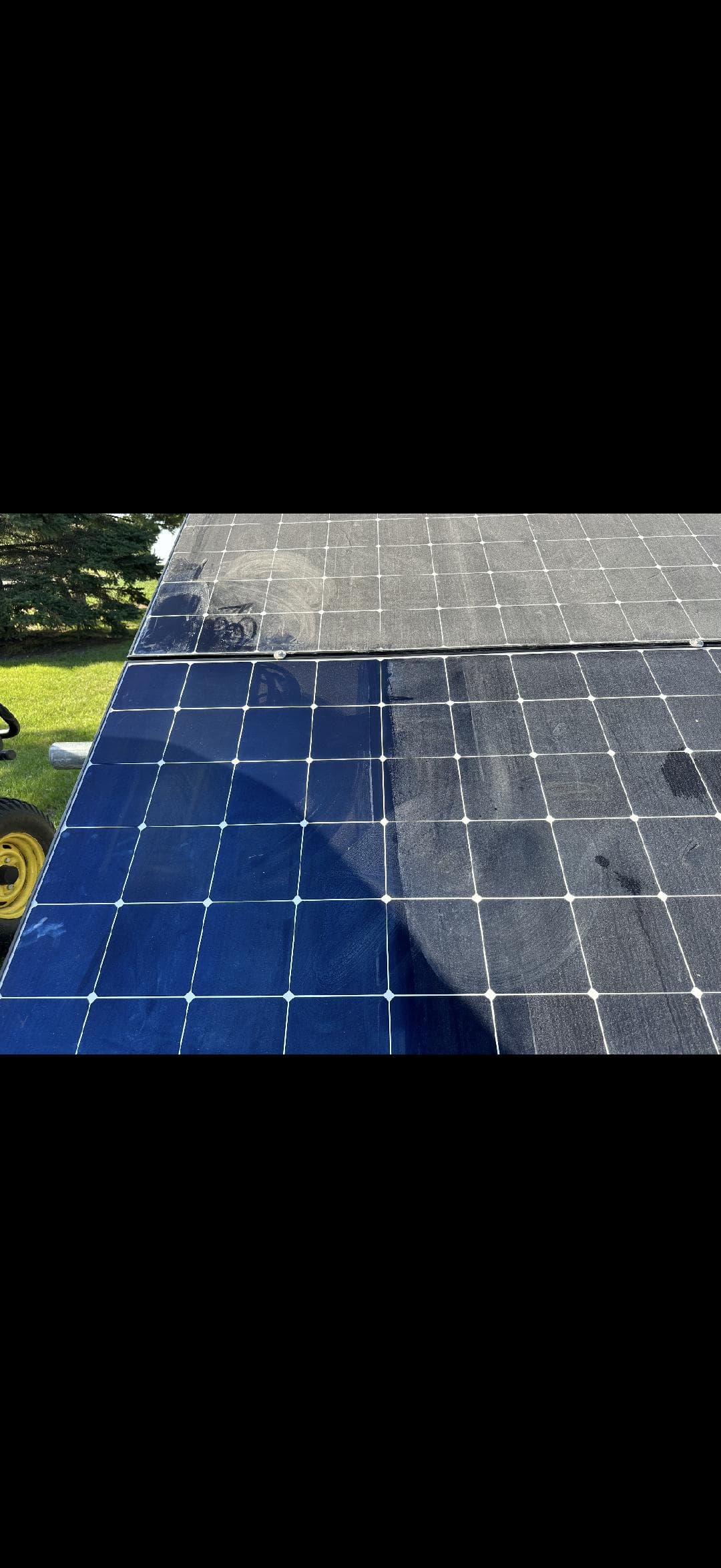 Solar panel mid-clean showing dust removed from one half