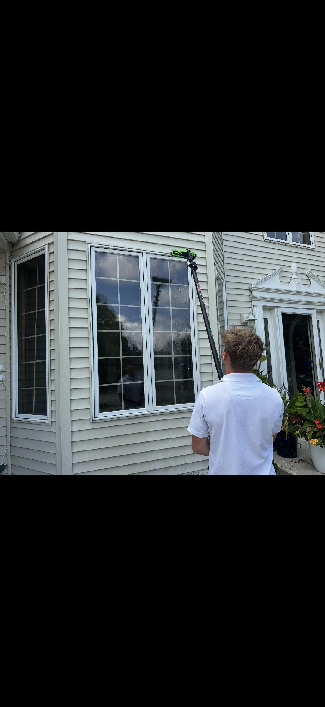 Water-fed pole window cleaning in progress